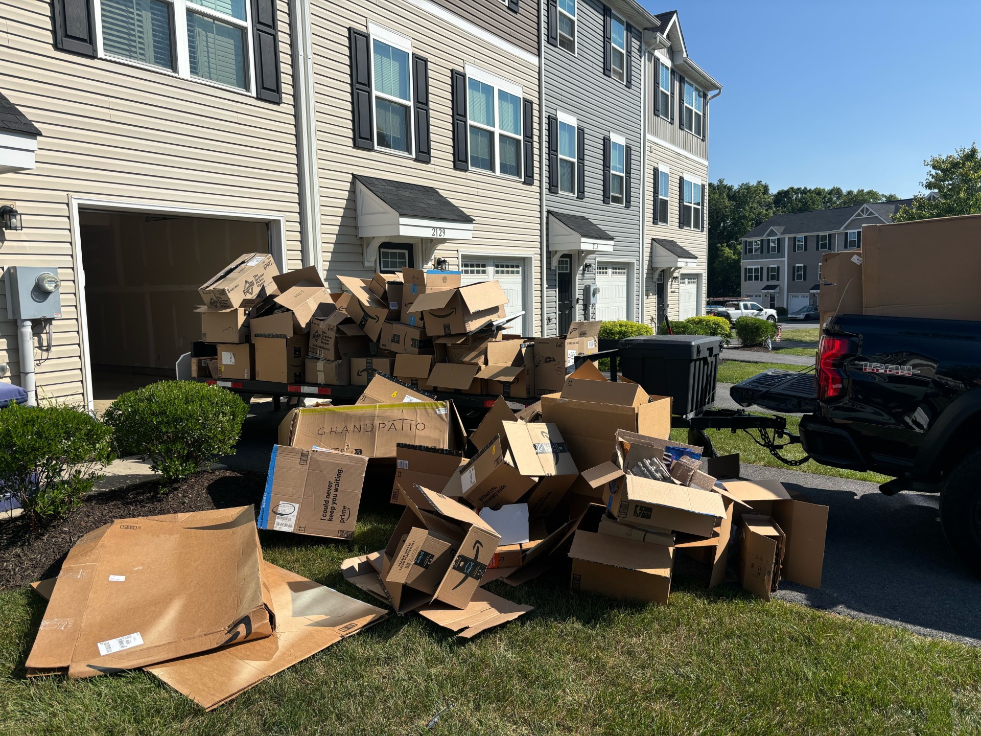 Pile of cardboard boxes cleared from a garage by Freedom Hauling