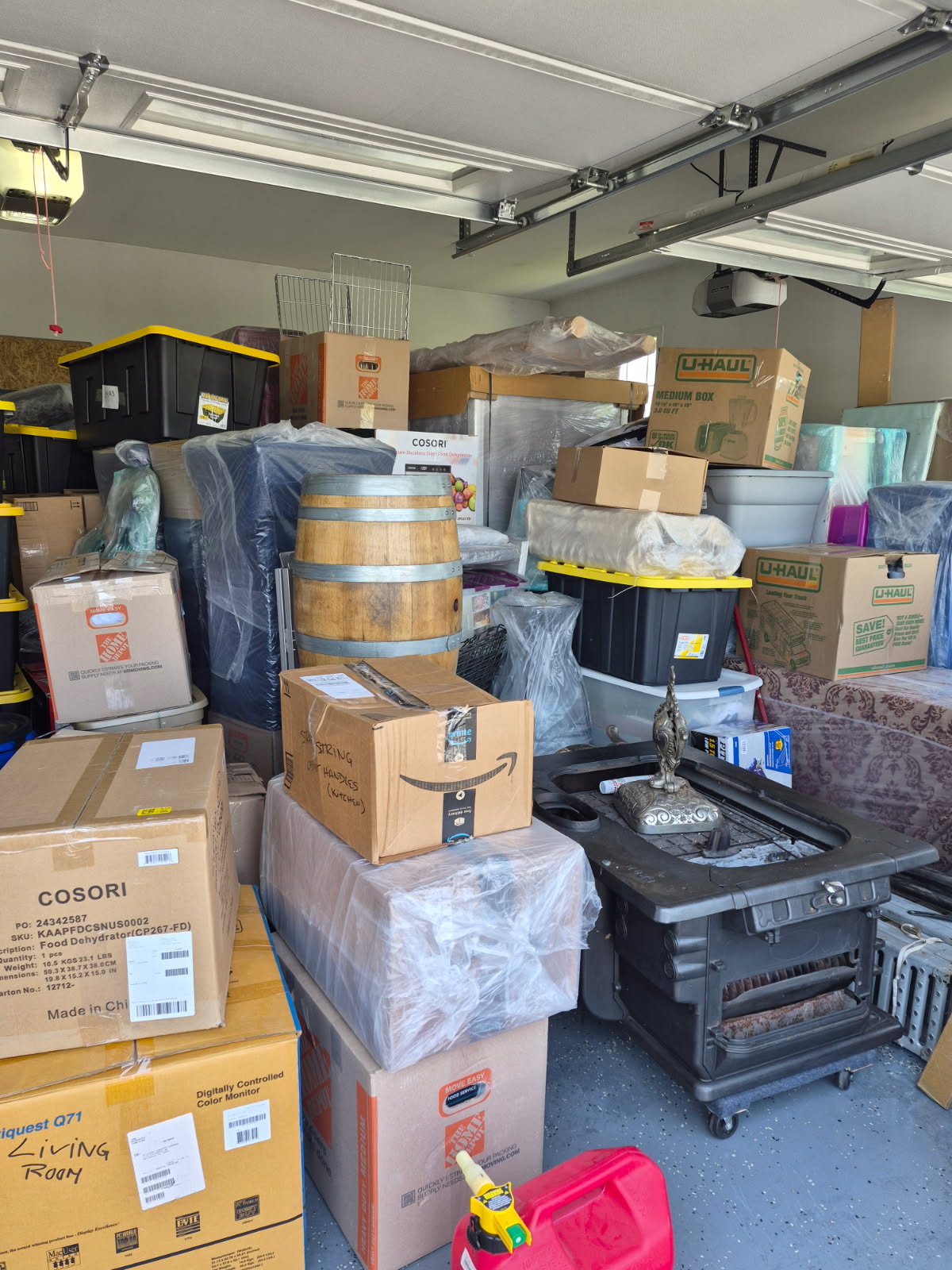 Garage stacked floor to ceiling with boxes, totes and household items